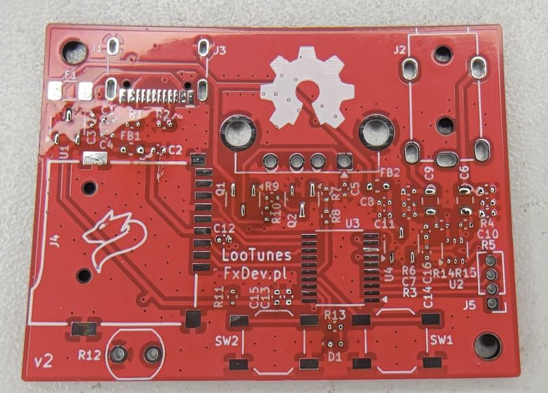 Red PCB with white silkscreen, labeled “LooTunes” and “FxDev.pl” at the center