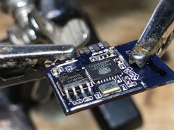 WiFi Module in Clip WiFi module with text on the surface held by tools.