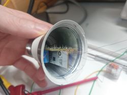 Interior of a light bulb with visible electronic circuit and wires.