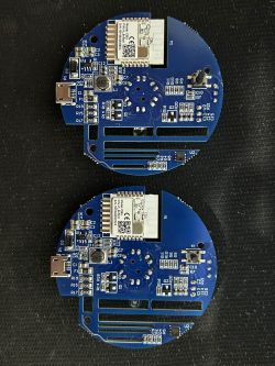 Two circuit boards with a WiFi module on a black background.