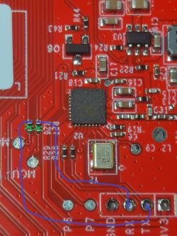 PCB with removed resistors and MCU connected to UART1 with a blue outline.