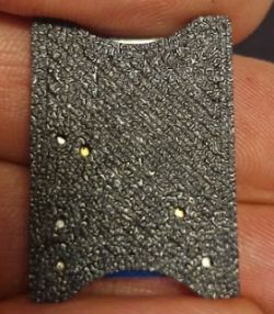 Close-up of the textured surface of a WBR3 module adapter held in a hand.
