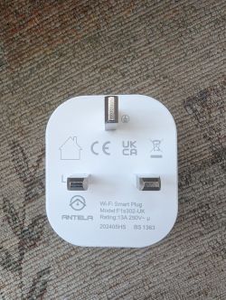ANTELA Wi-Fi Smart Plug Wi-Fi Smart Plug with three prongs on a carpet.