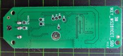 Green printed circuit board with technical labels.