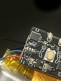 Zbliżenie na uszkodzoną płytkę PCB z odsłoniętą miedzią i oznaczeniami strzałkami.