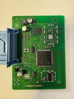 Close-up of a green circuit board with various electronic components.