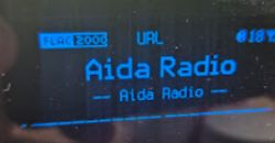 Display showing Aida Radio playing in FLAC 2000 kbps format