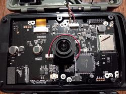 Image of the interior of an electronic device with a visible main board and a disconnected antenna.