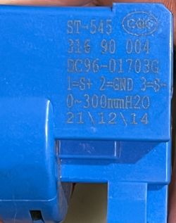 Close-up of a blue ST-545 pressure switch with printed technical markings