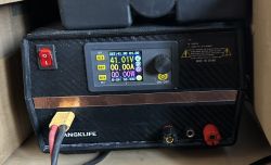 Power supply front panel with display showing 41.01 V and 0.00 A, banana jacks, and an XT60 connector