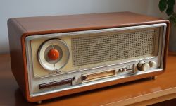 Retro Radio on Table Retro radio on a wooden table with a distinctive round knob.