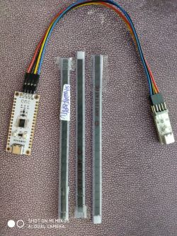 Microcontroller set with wires and several electronic components on a desk.