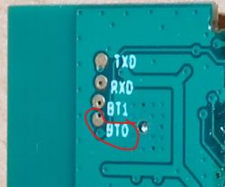 Close-up of a circuit board with pin labels TXD, RXD, BT1, and BT0.