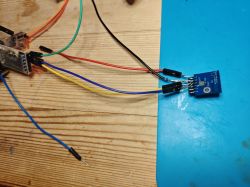Electronic Module with Connected Wires Electronic module connected to wires on a wooden table.