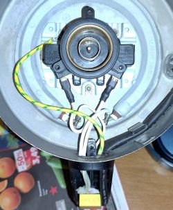 View of the interior of a Hoffek AK3502 electric kettle base with damaged components.