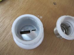 Open plastic tool on a wooden table.