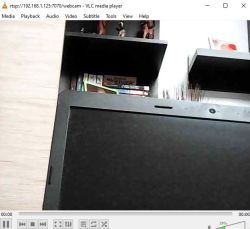 VLC screenshot showing a shelf with books and the lower edge of a monitor