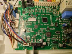 Gas boiler main control board with capacitors and connected multi-colored wires
