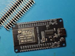 NiceMCU-WB5E development board with USB‑C and SparkleIoT module on a blue surface