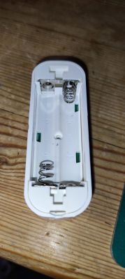 Inside of AAA Battery Casing View of the inside of a plastic casing with slots for AAA batteries.