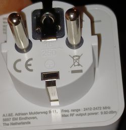 Rear View of Smart Plug with Markings Rear view of a white smart plug with visible metal prongs and manufacturer information.