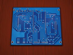 Blue PCB with signal traces and mounting holes, viewed from solder side