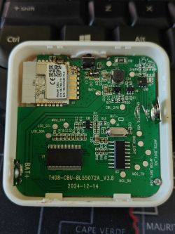Close-up of a printed circuit board with wires connected to RX, TX, GND, and 3V3 pins and visible reworked traces.