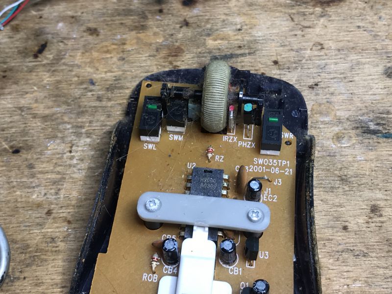 Inside Old Computer Mice Inside old computer mice with a visible scroll wheel and electronic circuits.