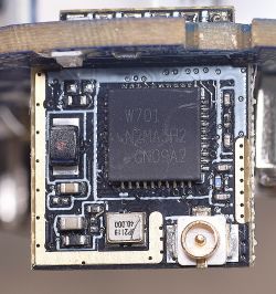 Close-up of a communication board with a W701 chip and U.FL connector.