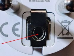 Close-up of an electrical socket with a metal bracket and CE symbol.