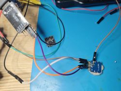 Wiring connections between various electronic modules on a blue surface.