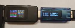 Dwa mierniki USB wskazujące wartości prądu i napięcia.