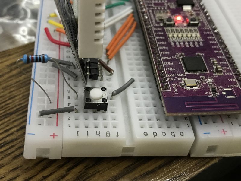 Microcontroller pushbutton circuit with pull-up resistor on breadboard Breadboard with microcontroller, pushbutton, and 10k pull-up resistor connected to VDD