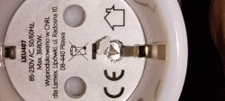 Bottom of Smart Socket with Triangular Screw View of the bottom part of a smart socket with the sticker removed, revealing a triangular screw head.