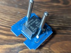 JIEYING JQF-SH-DC5V-1NO relay on blue PCB with two metal pins