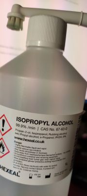Bottle of isopropyl alcohol with safety label.