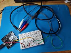 Breadboard with wires and an electronic module connected to a prototype board.