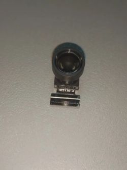 Small camera module with a front-facing lens on a light surface