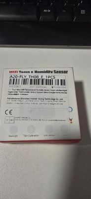 Box of WiFi temperature and humidity sensor A20-FLY TH08 near keyboard