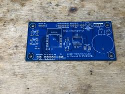 Blue PCB with electronic component markings for an LED clock.