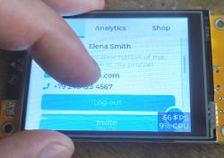 Interacting with ESP32-2432S028R Display Hand touching the LCD display showing user information segment.