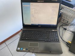 Acer Travelmate 7730 laptop with an open screen on a desk.