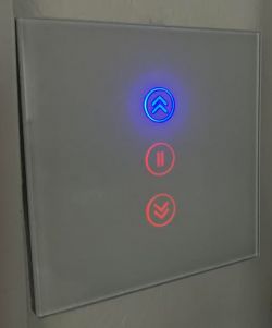 Touch panel with illuminated buttons: blue and red.