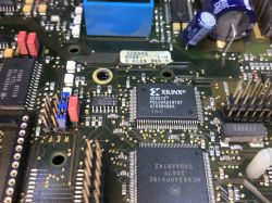 Close-up of a PCB showing a Xilinx XC9572 chip and nearby electronic components