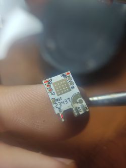 Close-up of an electronic module with pin labels.