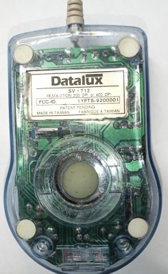 Transparent Datalux computer mouse, model SV-712, with visible internal electronic components.