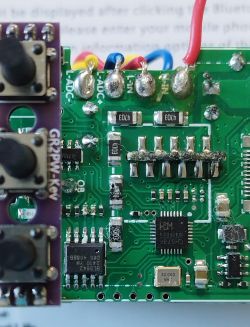 Close-up of a circuit board with visible electronic components, including attached wires and a CH573F microcontroller.