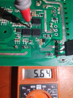 Measuring voltage on a circuit board with a multimeter.