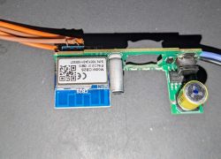 Dismantled circuit board with electronic components and a module labeled Model: CBZS.