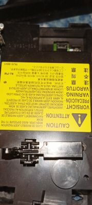 Żółta etykieta ostrzegawcza „LASER” na czarnym module z otworami i mechanizmem